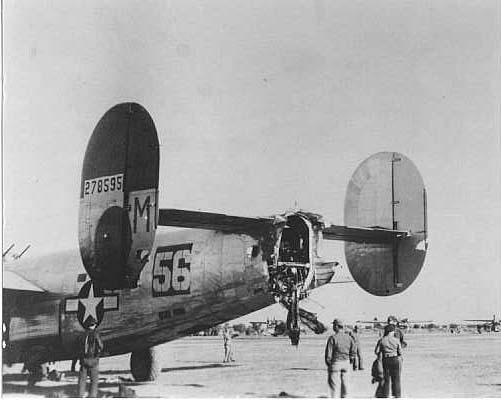 42-78595 shortly after landing at Foggia, Italy. Note the flack damage to fuselage and vertical stablizers